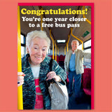 A funny birthday card with a modern picture of two smiling pensioners looking to camera on a bus. White and yellow text above reads Congratulations You're one year closer to a free bus pass.