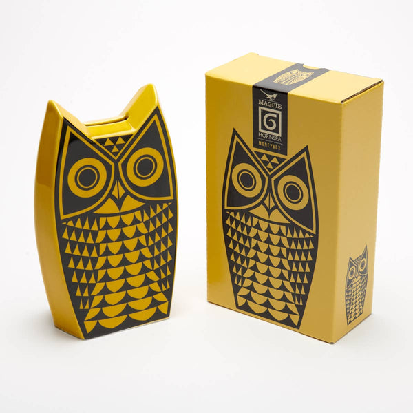Magpie x Hornsea Owl Moneybox - a ceramic owl shaped yellow money box with an owl design in black presented with a matching gift box
