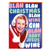 A Christmas card with a 1960s picture a young woman smiling wearing a winter hat and mittens. Big squishy pastel festive coloured text around her reads Blah blah Christmas blah wine gin blah baby Jesus wine.