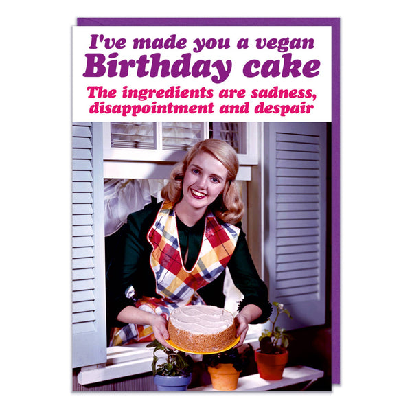 A birthday card with with a 1950s style picture of a housewife leaning out of a window holding a cake. Purple and pink text above reads I've made you a vegan birthday cake. The ingredients are sadness, disappointment and despair.