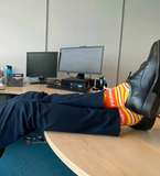Parmo socks worn with a suit with feet up on the desk