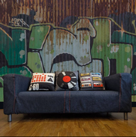 C-60 Cassette Tape Retro Velvet Cushion shown on a sofa with other cushions against a graffiti wall