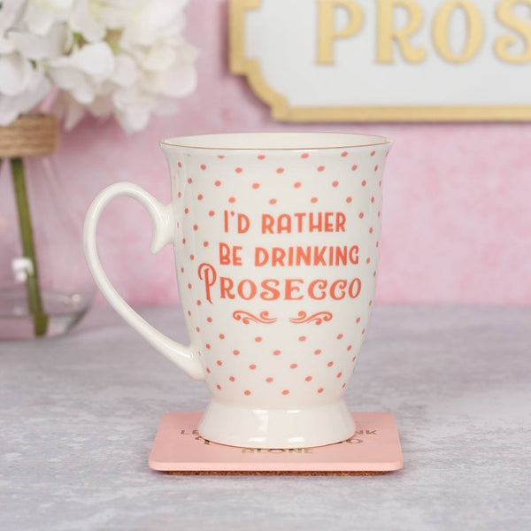 Pretty white china mug with pink polka dots and metallic gold details. Featuring text that says 'I'd Rather Be Drinking Prosecco'